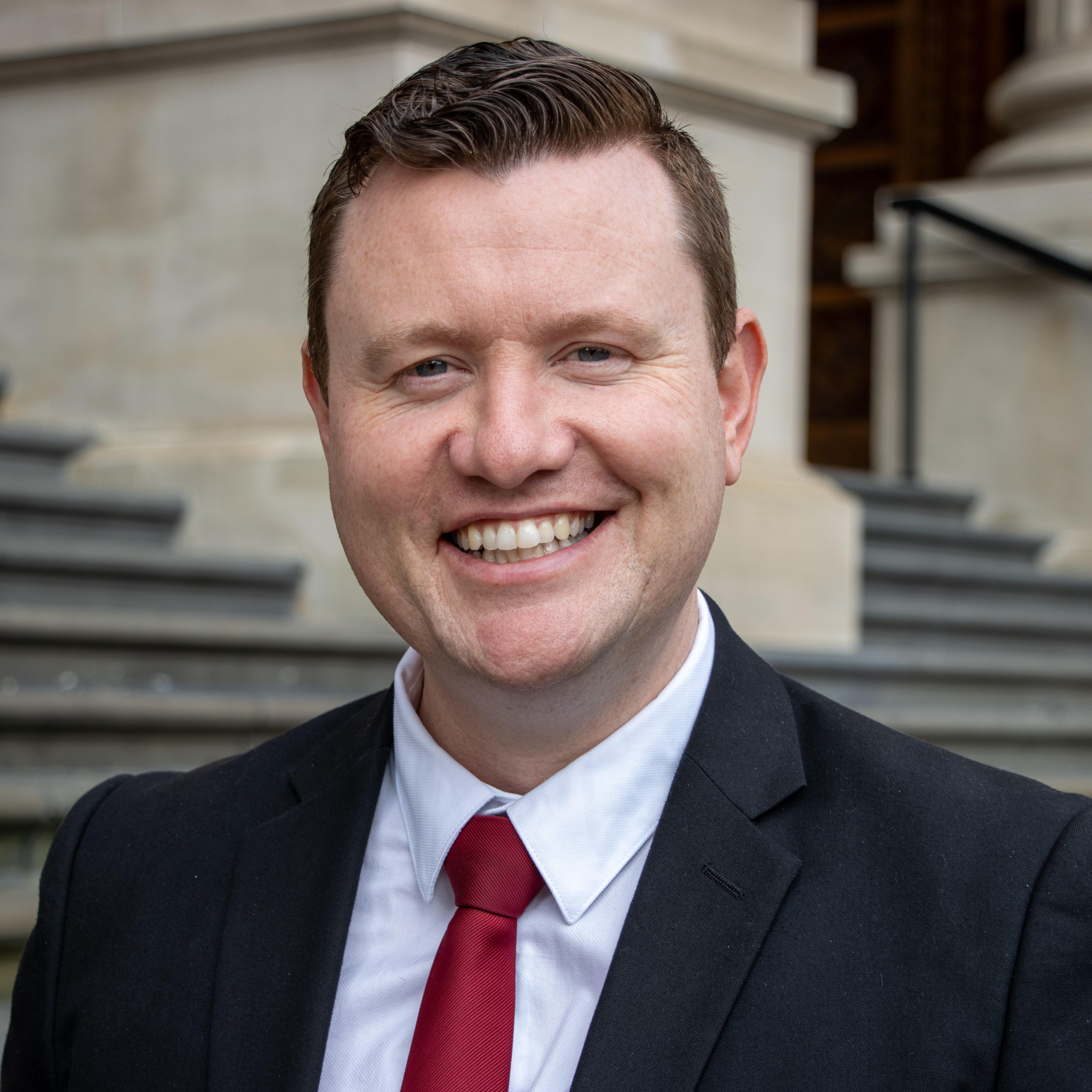 Tim Richardson headshot on steps of the Parliament of Victoria